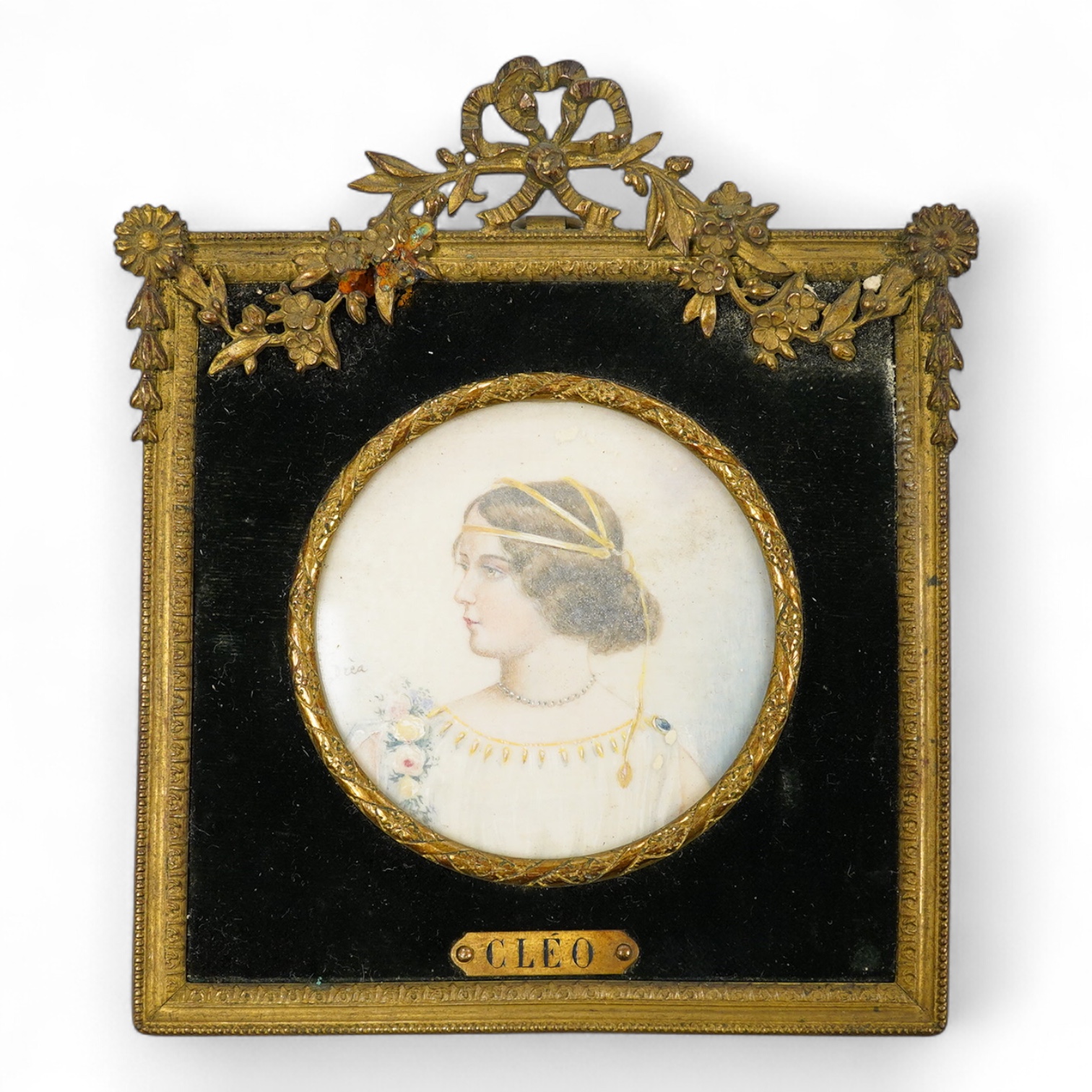 Drea, early 20th century School, Portrait miniature ‘Cleo’, Pre-Raphaelite style, tondo watercolour on ivory, signed, housed in an ornate gilt metal frame, overall 11cm high - CITES Submission reference KB82XPEQ